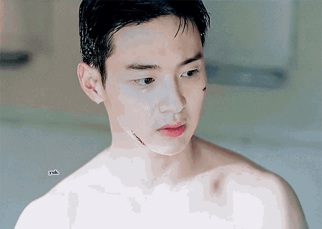 a close up of a shirtless man 's face with a drawing of a cloud on the bottom right