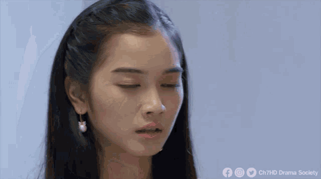 a close up of a woman with her eyes closed