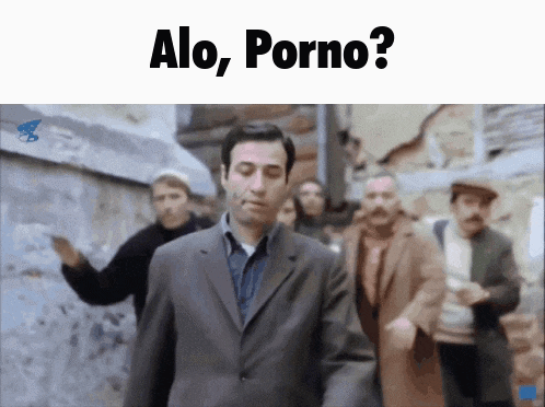 a man in a suit is walking down a street with a group of people behind him and the words alo porno on the bottom