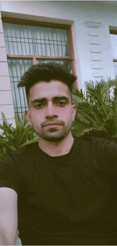 a man taking a selfie in front of a window