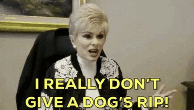 a woman is sitting in a chair saying i really don 't give a dog 's rip .