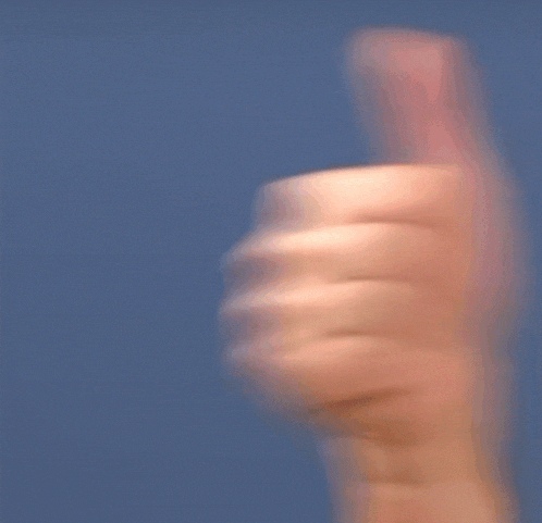 a blurry picture of a person 's hand giving a thumbs up