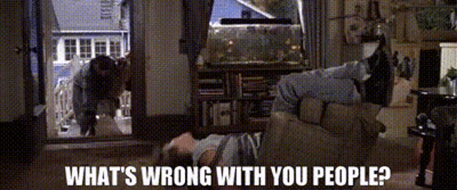 a man laying on the floor with the words " what 's wrong with you people "