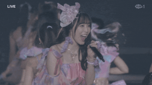a group of girls are dancing in front of a live audience