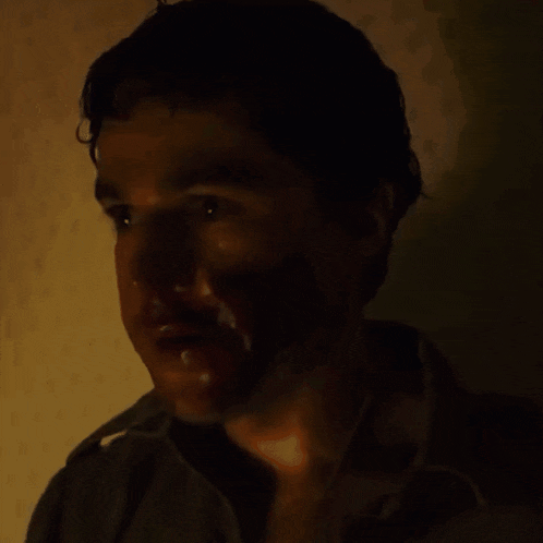 a close up of a man 's face in the dark with his eyes closed