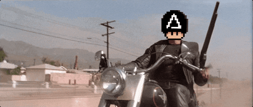 a man is riding a motorcycle with a pixelated a on his helmet