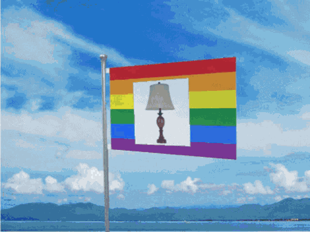a rainbow flag with a lamp in the middle