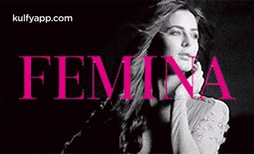a woman is standing in front of a sign that says femina .