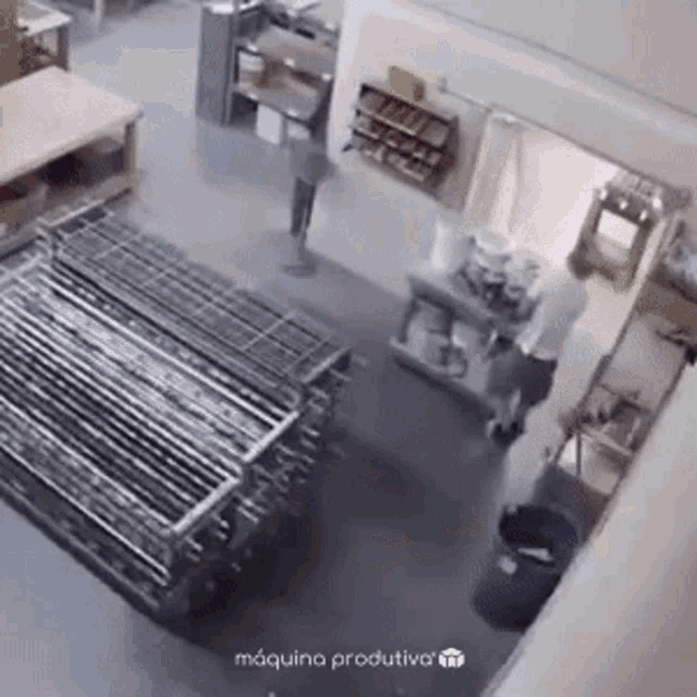 a man is standing in a room next to a stack of metal tubes .