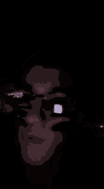 a close up of a person 's face wearing glasses