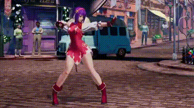 a woman in a red dress is standing on a cobblestone street holding a sword .
