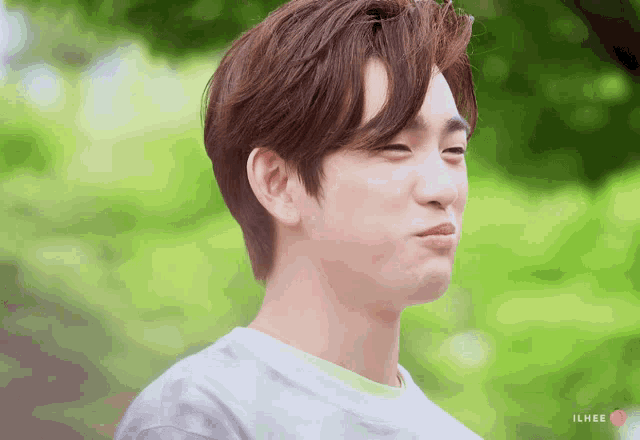 a close up of a person 's face with the word ilhee on the bottom left