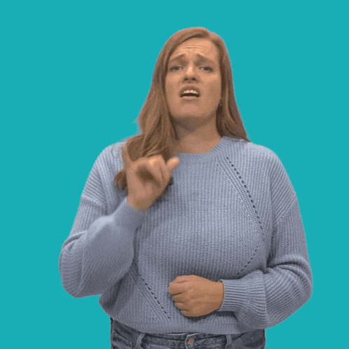 a woman in a blue sweater makes a funny face