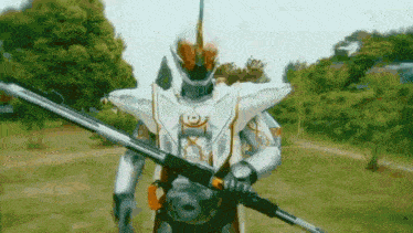 a robot is holding a long sword in a field .