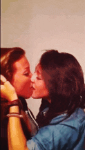 two women kissing each other on the cheek