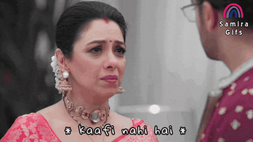 a woman in a pink saree is crying while looking at a man with the words kaafi nabi hai written below her