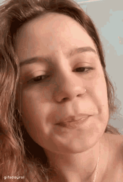 a close up of a woman 's face with the words gifsdayrol on the bottom