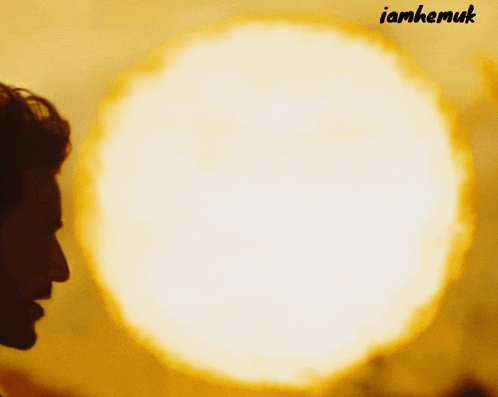 a silhouette of a man in front of a large sun with the name ianhemuk below him