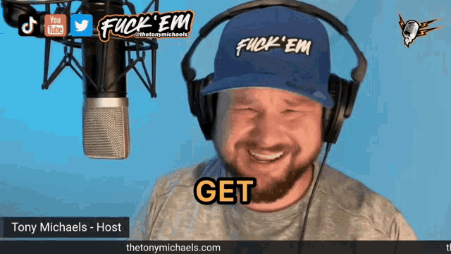 a man wearing headphones and a blue hat says get