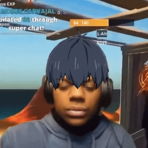 a man wearing headphones is playing a video game and has a cartoon character on his head