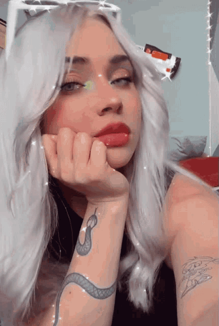 a woman with a snake tattoo on her wrist