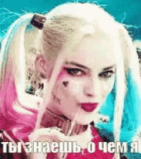 a woman in a harley quinn costume is holding a lollipop .