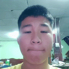 a close up of a man 's face with a yellow shirt on