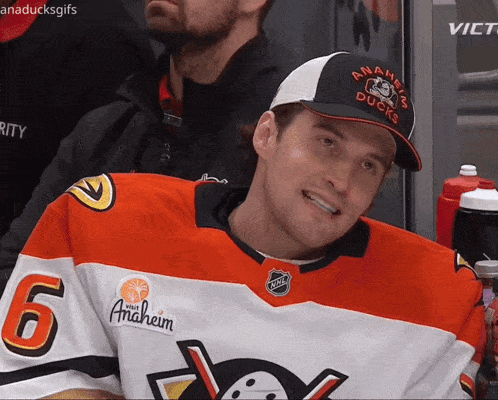 a man wearing a hat that says anaheim ducks is smiling