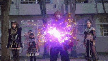 a group of people standing in front of a building with a purple light coming out of their chests .