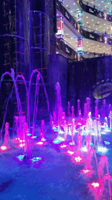 a fountain in front of a building that has dior on it