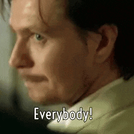 a close up of a man 's face with the words " everybody " written on it .
