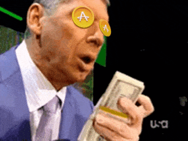 a man in a suit and tie is holding a stack of money and a coin with the letter a on it