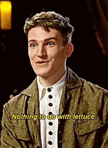 a young man wearing a green jacket and a white shirt is talking about lettuce .