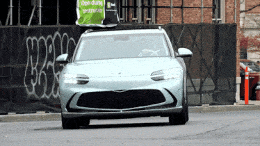a car with a bag on top that says open during construction on it