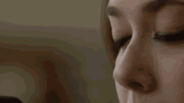 a close up of a woman 's face with her eyes closed and her nose visible .