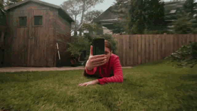 a person is holding a cell phone in their hand .