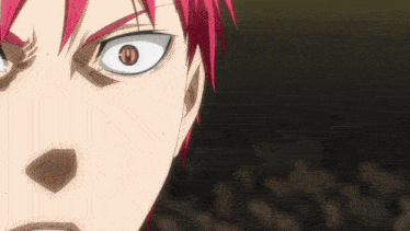 a close up of a man 's face with red hair