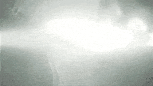 a black and white photo of a person in a foggy room