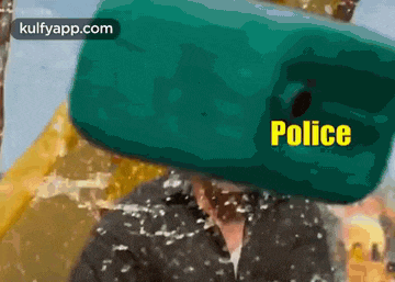 a man wearing a police hat is covered in water