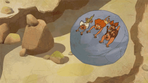 a group of cavemen are laying on top of a large rock