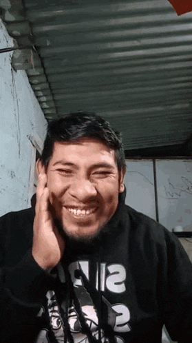 a man wearing a black shirt with the letters n12 on it