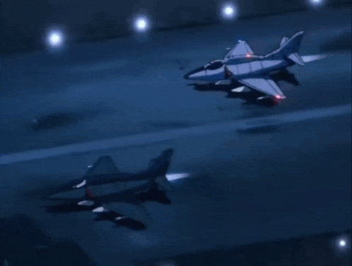 a couple of fighter jets are flying in the dark