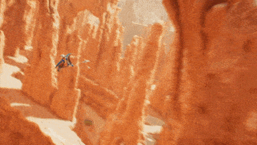 a person is flying through a canyon with a jet
