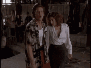 a man and woman are holding hands in a room