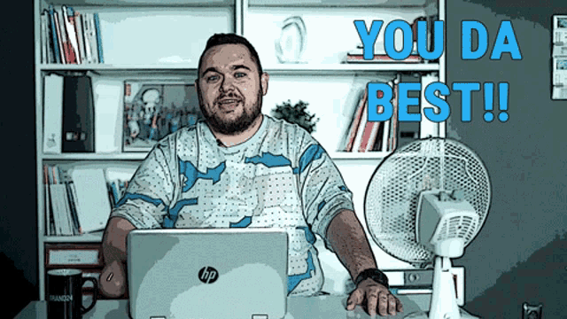 a man sitting in front of an hp laptop with the words you da best behind him