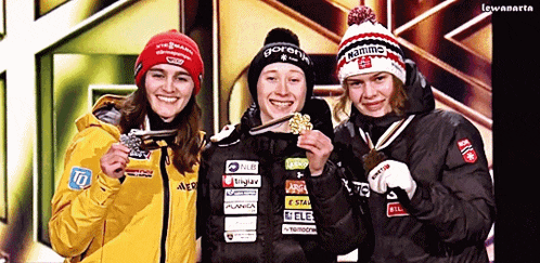 three female athletes are posing for a picture and one of them has a hat that says flamme on it
