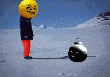 a person with a smiley face on their head stands next to a bomb in the snow