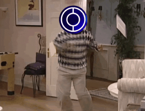 a man in a striped shirt is dancing in a living room with a circle on his head .