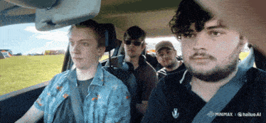 a group of men are sitting in a car with a banner that says minimax