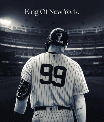 a baseball player with the number 99 on his back stands in front of a stadium